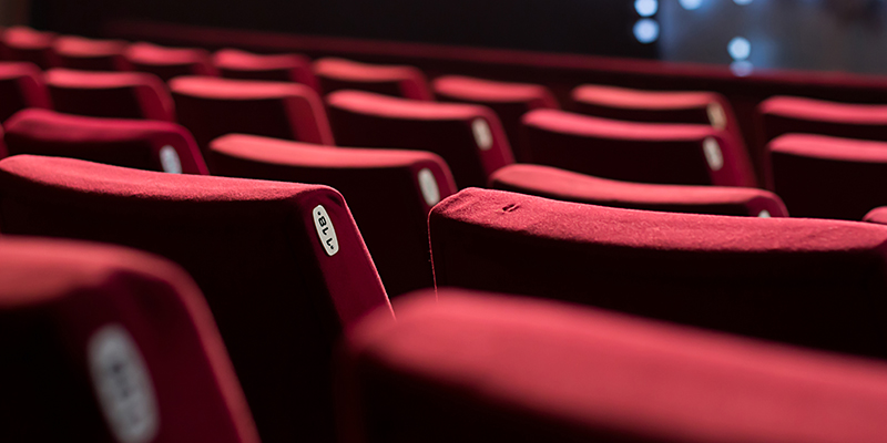 Empty theater with red chairs. Rear view.