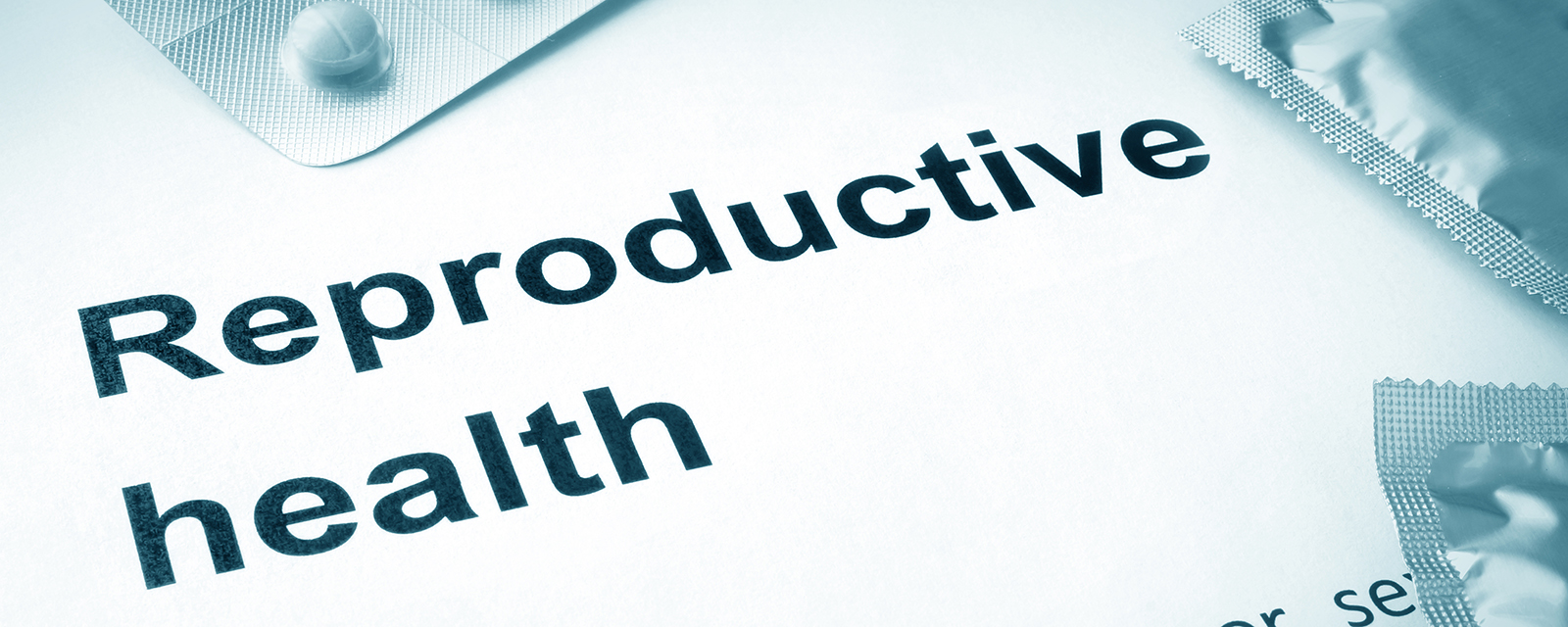 Paper with words reproductive health and contraceptives.