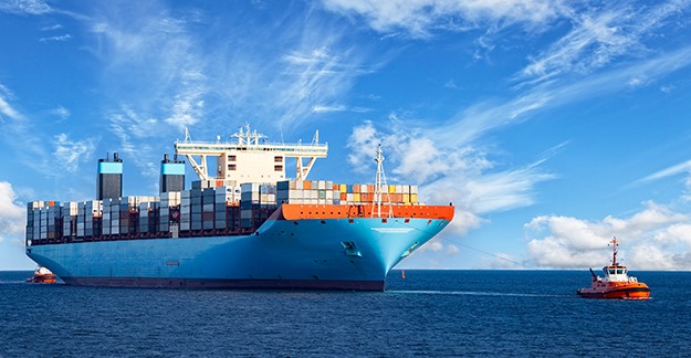 Tugboat towing container ship