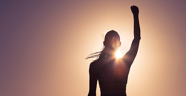 Woman raising arm in victory