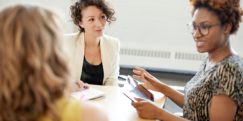 Candid picture of a female boss and business team collaborating