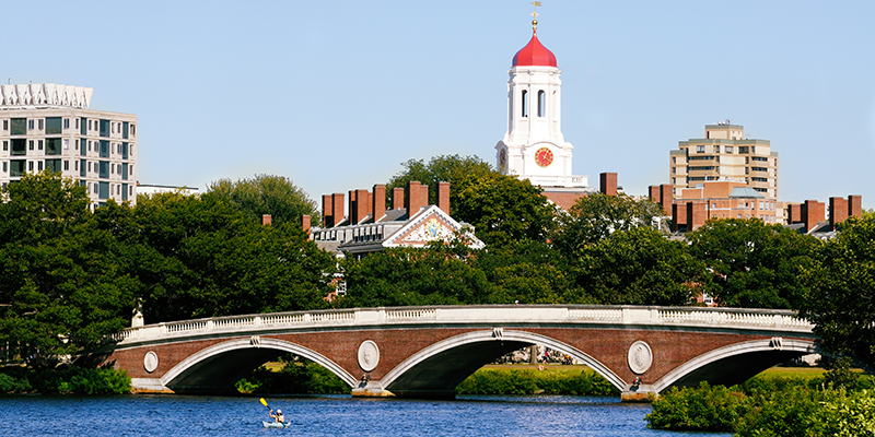 View of Harvard University and pedestrian bridge on Charles River in Cambridge, Massachusetts