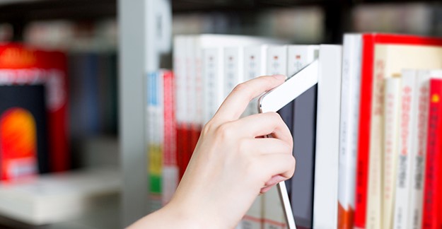 Tablet on a shelf of books