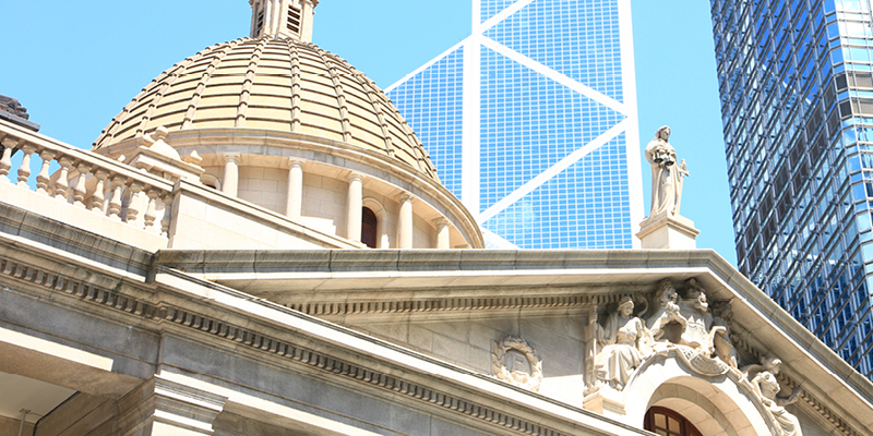 Courthouse exterior with skyscrapers in background