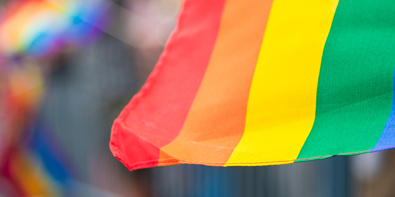Blurred picture of a gay rainbow flag at a pride parade