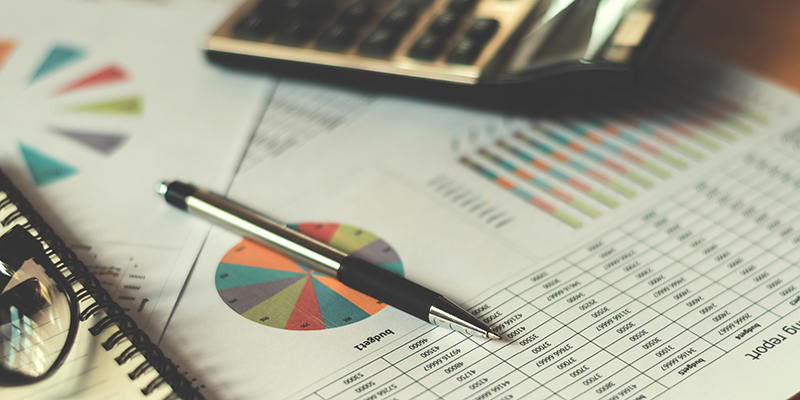 business financial concept with calculator pen and accounting report in office