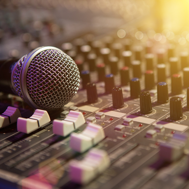 Microphone resting on a sound console in a recording studio