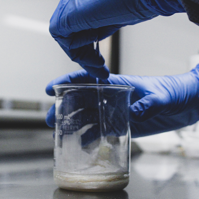 Example of a lab technician mixing a pharmaceutical compound.