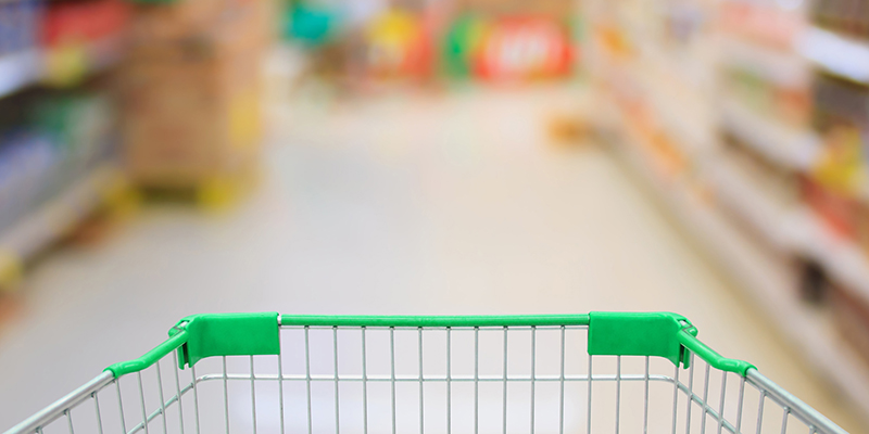 Supermarket interior with shopping cart