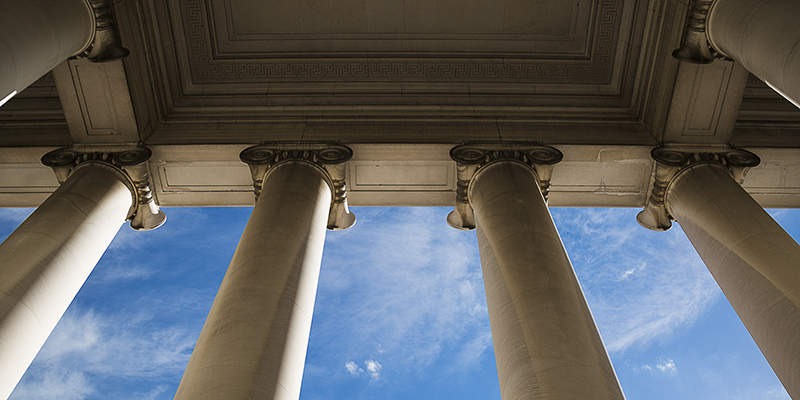 Building column on a government building with a beautiful blue sky.