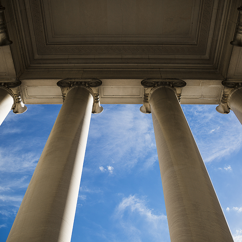 Building column on a government building with a beautiful blue sky.
