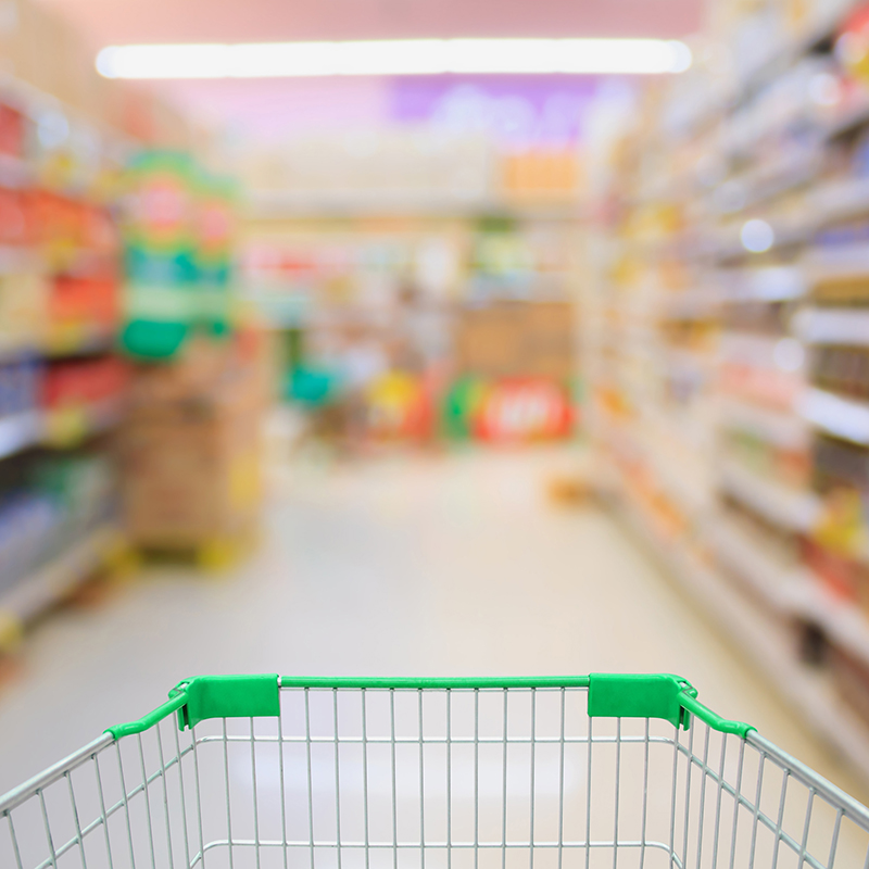 Supermarket interior with shopping cart