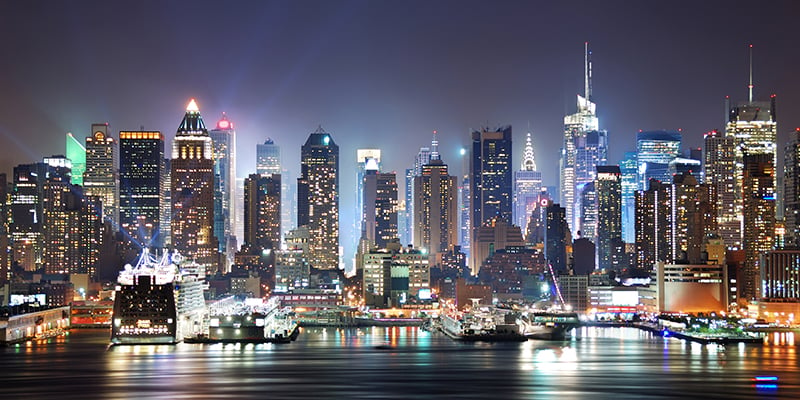 New York City Manhattan skyline panorama at night over Hudson River with reflections viewed from New Jersey