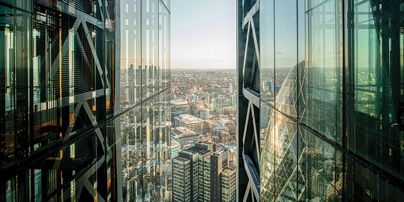 Cityscape of London reflecting in office building windows
