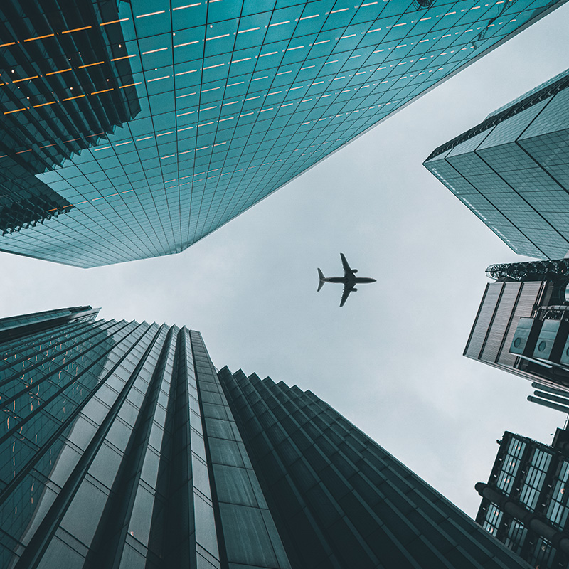 Plane flying between two skyscrapers
