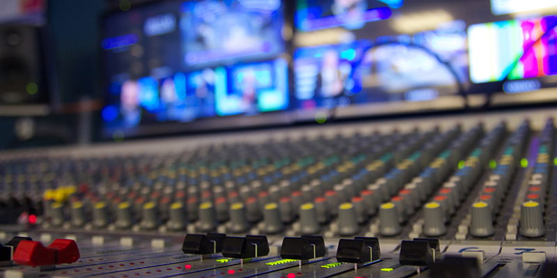 A multi channel audio mixer on a television station with shallow depth of field.