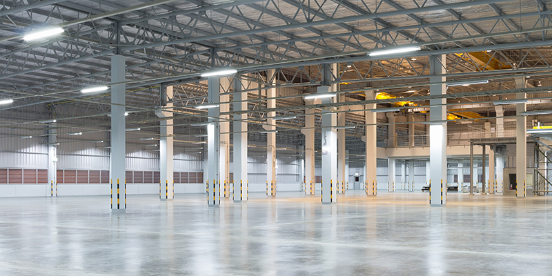 Empty factory building or warehouse building with concrete floor for industry background.