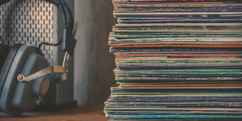 headphones and stack of vinyl records