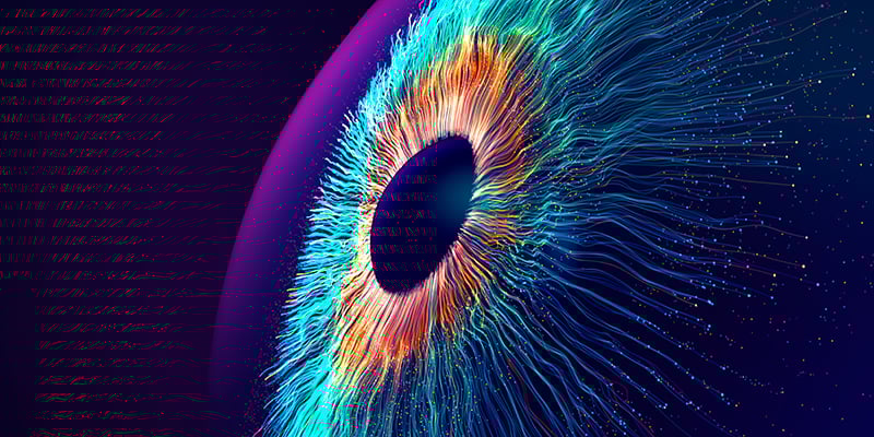 Digital generated image of multicolored particles forming eye shape against black background.