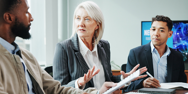 Two men and a woman in a meeting