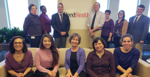 Philadelphia office employees standing and sitting for a picture