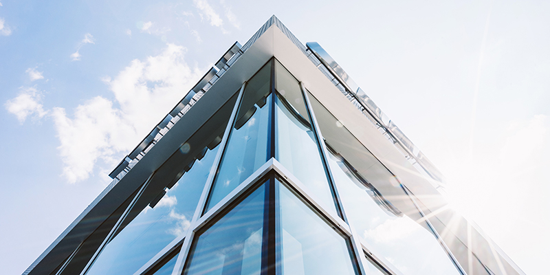 Upward view of the exterior of a glass building