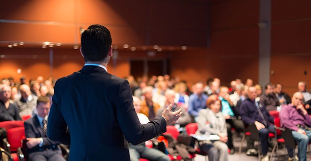 Man speaking in front of a conference