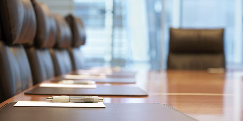 empty boardroom with pens and folders