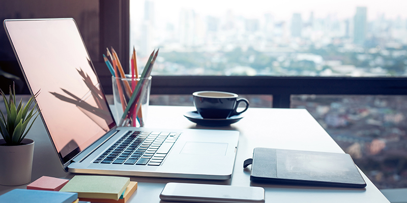 Modern work table with computer laptop and cityscapes viewfrom window.Business concepts ideas.Strategy analysis