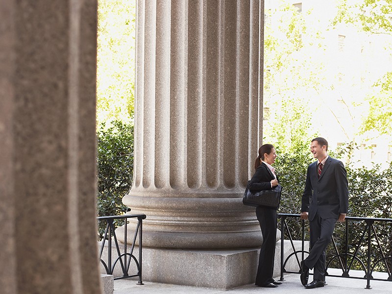 Woman and man standing outside courthouse