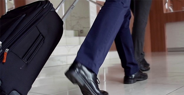 Man pulling suitcase
