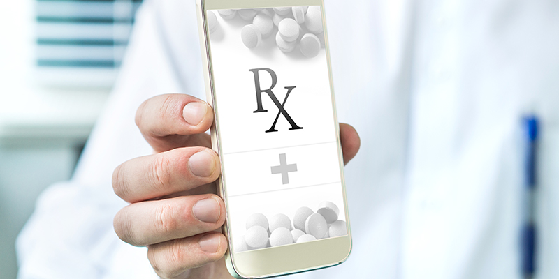 Doctor holding electronic device with prescription symbol