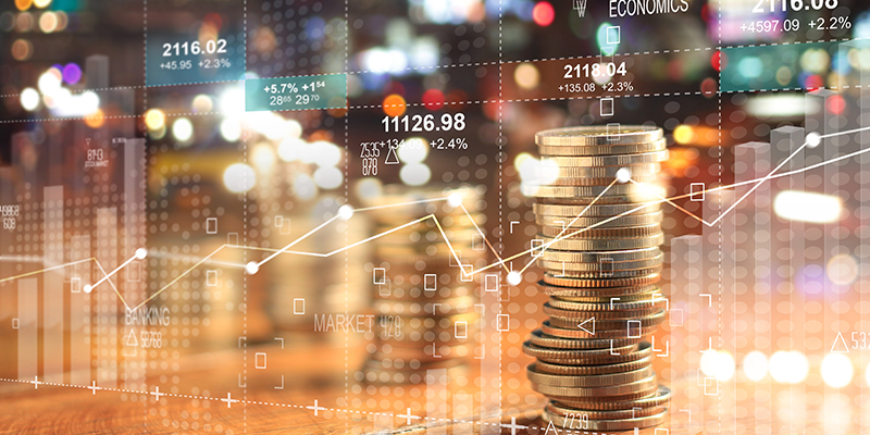 Double explosure with businesss charts of graph and rows of coins for finance at night city background