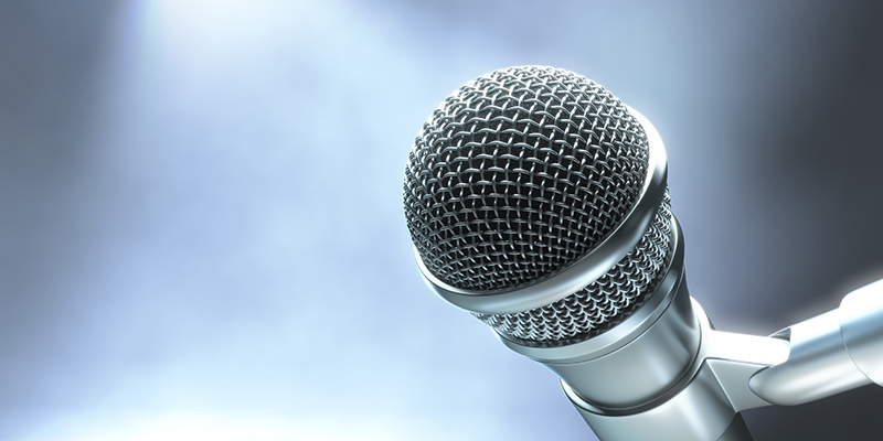 Modern microphone on a stage with lights for live performance.