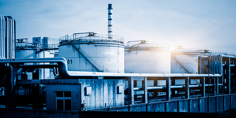 storage tanks and pipelines at the oil refinery, blue toned image