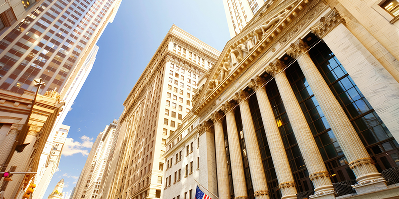 View of towering skyscrapers and historic buildings in New York City's Financial District, showcasing the heart of global finance.