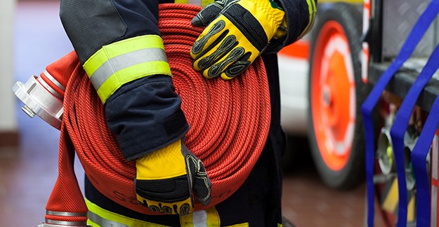 Firefighter holding firehose