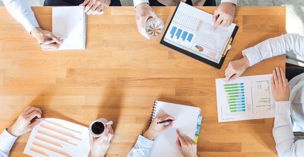 Overhead view of meeting table with documents