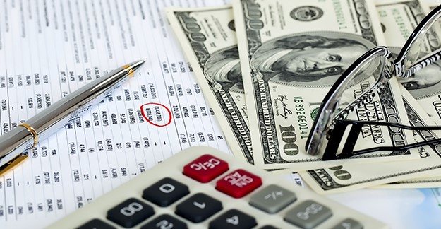 Money, calculator, glasses and pen
