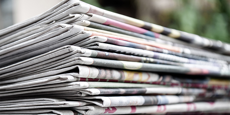 Newspapers folded and stacked in a pile