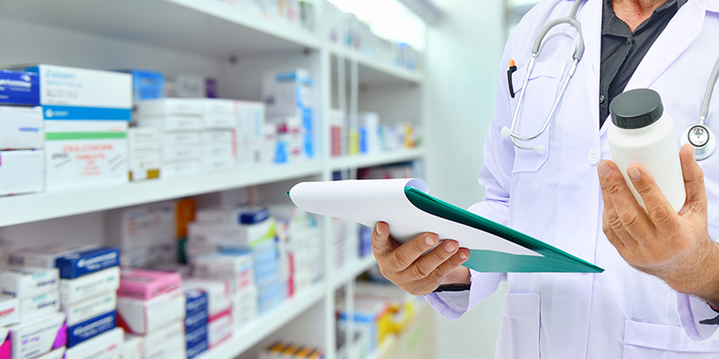 Pharmacist filling prescription in pharmacy drugstore