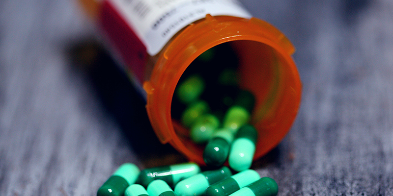 Pills spilling out of an open pill bottle