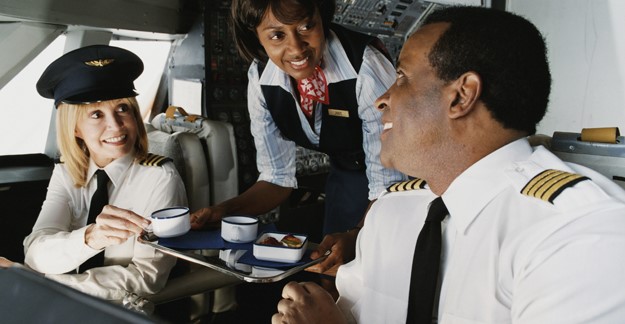 Two pilots and flight attendant in the cockpit