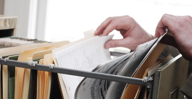 Searching through filing cabinet