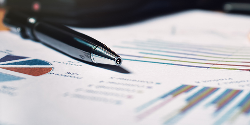 Close up pen on paperwork and woman hand calculate finance