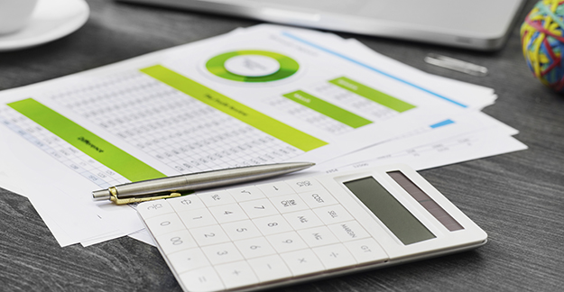 Financial documents, pen, and calculator