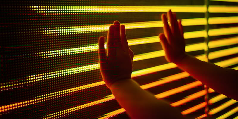 Child hands touching LED screen