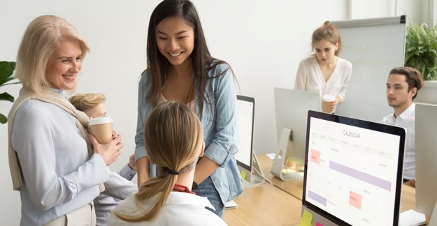 Women talking near a computer